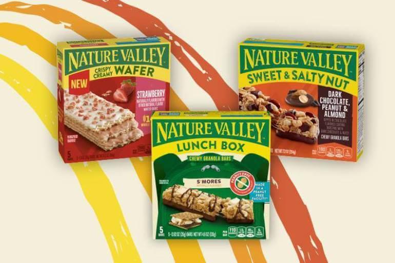 Illustrated graphic showing three boxes of Nature Valley Wafer, Sweet & Salty and Lunch Boxes. Flavors are: Strawberry, S'Mores and Dark Chocolate Peanut Almond, front of 5 bar boxes.