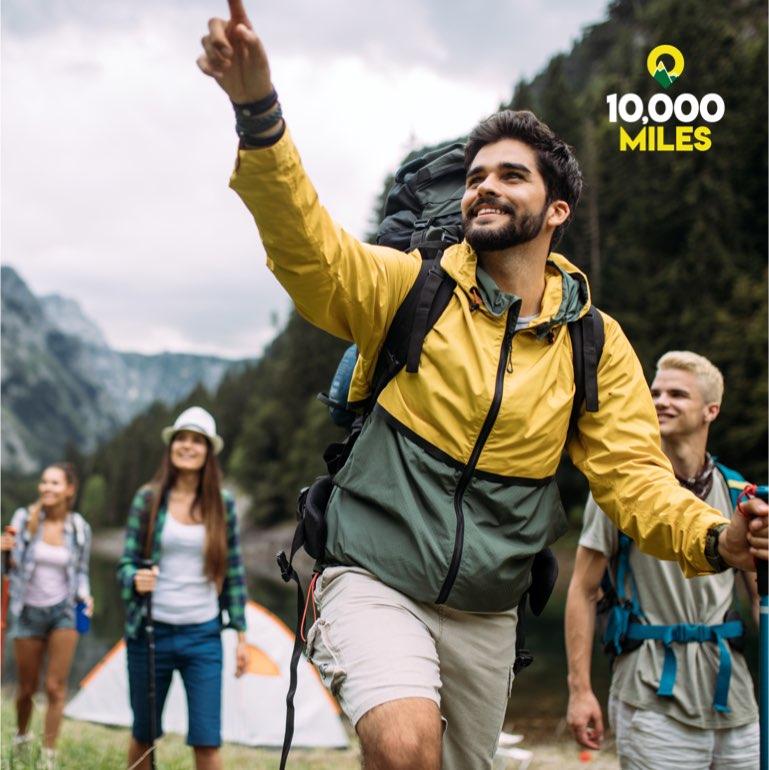 10,000 miles: A man with a beard leads a group of people on a hike.